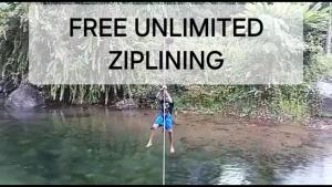 a person hanging from a rope in the water at 3 Rivers Eco Lodge in Rosalie