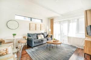 a living room with a couch and a table at 809-5A Gorgeous New 1BR Heart of Midtown in New York