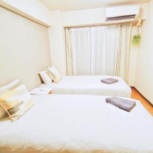 Łóżko lub łóżka w pokoju w obiekcie 新宿市中心歌舞伎町伊势丹徒步3分钟#1