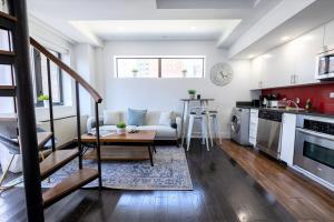 a kitchen and living room with a couch and a table at 809-6B New 2BR Duplex With Private Patio in New York
