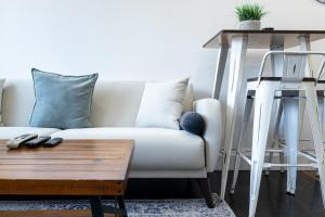 a living room with a white couch and a table at 809-6B New 2BR Duplex With Private Patio in New York +41 photos