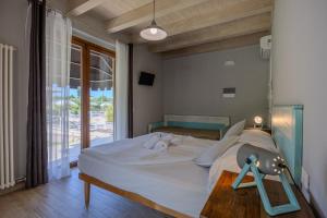 a bedroom with a bed and a large window at Villa Maddalena in Bardolino +75 photos