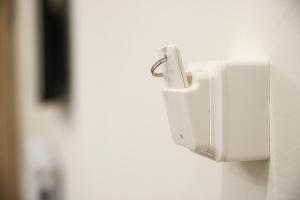 a white soap dispenser on a wall at #A Ιoanna's Apartments in Thessaloniki