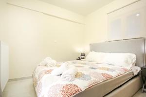 a bedroom with a bed with towels on it at #A Ιoanna's Apartments in Thessaloniki
