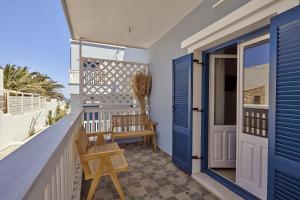 a balcony with blue doors and a bench at Aroma Kastellia - Althea Homes in Amoopi +16 photos