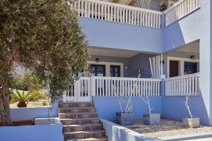 a blue house with stairs and a tree at Aroma Kastellia - Althea Homes in Amoopi