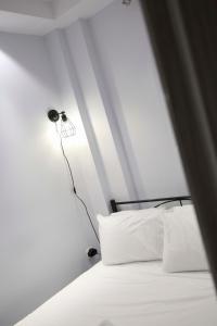 a bedroom with a bed with a lamp next to it at #D Ioanna Apartments in Thessaloniki