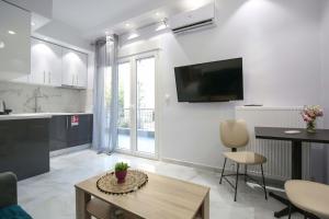 a living room with a tv on the wall at #D Ioanna Apartments in Thessaloniki