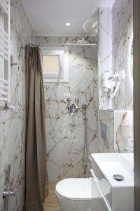 a bathroom with a toilet and a sink and a shower at #D Ioanna Apartments in Thessaloniki