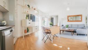 a kitchen and living room with a couch and a table at Casa Acropolis - Stunning 3Br Apt with Private Terrace in Athens