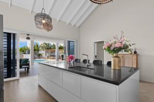 a kitchen with a large island with a counter top at Villa Perla di Solo, 6 persoons, met privézwembad en groot dakterras met zeezicht! in Grote Berg