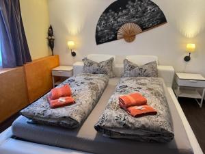 two beds with pillows on them in a room at Hotel Bären Amriswil in Amriswil