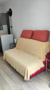 a bed with red pillows on top of it at Fenouillet in Hyères