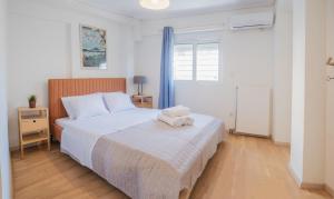 a bedroom with a bed with a towel on it at Casa Acropolis - Stunning 3Br Apt with Private Terrace in Athens