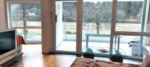 a living room with a couch and a sliding glass door at Panoramalounge Moselblick - Toplage in Traben-Trarbach +2 photos