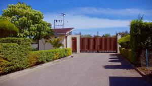 a driveway leading to a house with a red fence at La Casa Savanna in Naivasha +10 photos