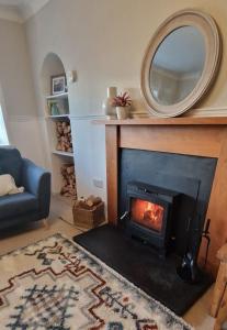 a living room with a fireplace with a mirror at North Coast Property - Avoch Beach House - Luxury house with sea views in Avoch