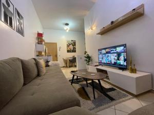 a living room with a couch and a flat screen tv at Chez vous à Skhirate in Skhirat