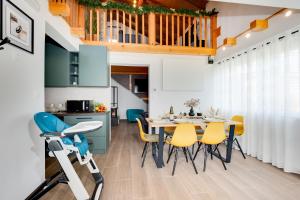 a kitchen and dining room with a table and chairs at Holiday home ZEN in Vinkovac