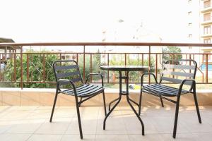 two chairs and a table on a balcony at #Ioannas Νikopolis Apartments in Thessaloniki