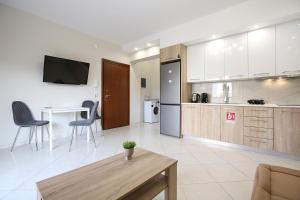 a kitchen with a table and chairs in a room at #Ioannas Νikopolis Apartments in Thessaloniki