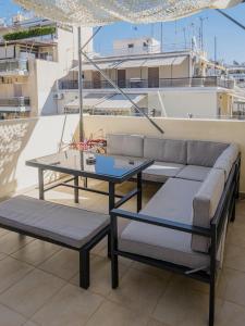 a living room with a couch and a table at Casa Acropolis - Stunning 3Br Apt with Private Terrace in Athens