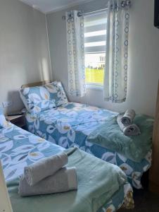 a bedroom with two beds and a window at The Edsley in Eyemouth