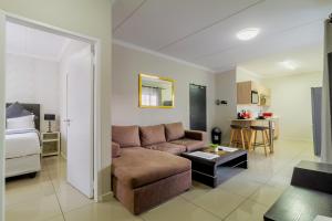 un salon avec un canapé et un lit dans l'établissement Buckingham Palace 2 Bed 2 Bath, à Midrand