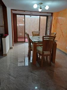 a dining room with a wooden table and chairs at El Palmar in Palmira +10 photos