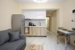 a living room with a couch and a kitchen at #B Ioanna's Apartments in Thessaloniki +9 photos