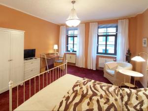 a bedroom with a zebra print bed and a living room at City-Ferienwohnungen-Dresden - zentral gelegen im Haus Louisenstrasse 11 - Dresden-Neustadt in Dresden