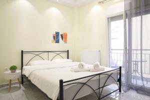 a bedroom with two white towels on a bed at #5 Ioanna Apartments in Thessaloniki
