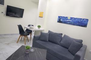 a living room with a couch and a table at #5 Ioanna Apartments in Thessaloniki