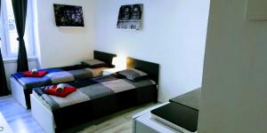 a bedroom with two beds with red pillows on them at Pula-Center Apartments and Rooms in Pula