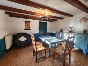 a living room with a table and chairs and a couch at Maison de Vacances in Le Thillot
