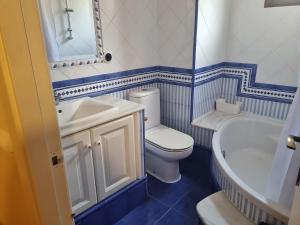a blue and white bathroom with a toilet and a sink at Les Dos Nines in Monserrat +16 photos