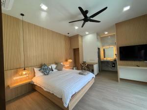a bedroom with a large bed with a ceiling fan at Aonang nine poolvilla resort in Ao Nang 