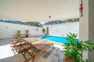 a patio with a pool and a table and chairs at LİV Villa in Marmaris