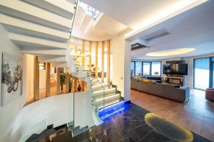 a living room with a staircase in a house at LİV Villa in Marmaris