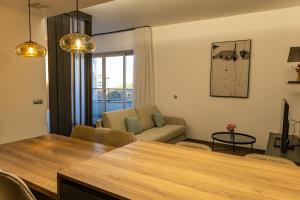 a living room with a table and a couch at Guillman Suites in Alicante
