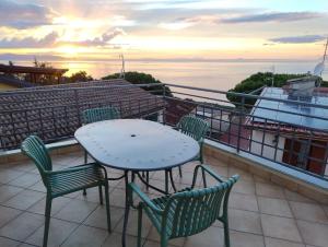 a table and chairs on a balcony with a view of the ocean at B&B Vista Mare "Terrazzo" in Palmi