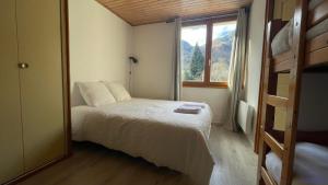 a small bedroom with a bed and a window at Chambres Quentin in Laruns