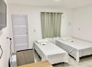 Ένα ή περισσότερα κρεβάτια σε δωμάτιο στο Hospedaria Dona Santa