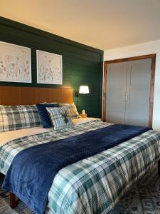 a bedroom with a large bed with a blue blanket at Newly Renovated Ski In Ski Out 2BR Condo in Crested Butte