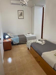 a room with two beds and a chandelier at Sweet Home Sofia in Norma