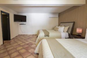 Postel nebo postele na pokoji v ubytování Hotel Posada Terranova