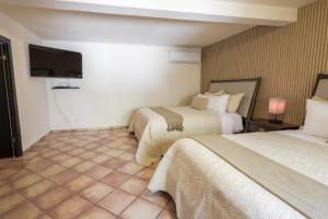 Postel nebo postele na pokoji v ubytování Hotel Posada Terranova