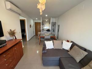 a living room with a couch and a dining room at Villa Eric in Roldán