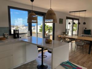 a kitchen with white cabinets and a large window at Villa Chona in El Cuchillo