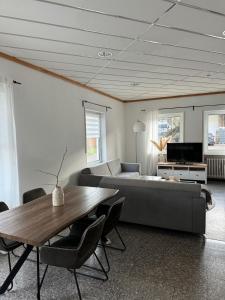 a living room with a couch and a table at Ferienhaus Alte Bank in Göcklingen in Göcklingen